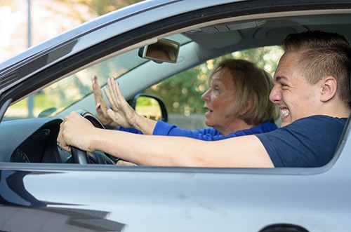 man and woman in car bracing for impact sm