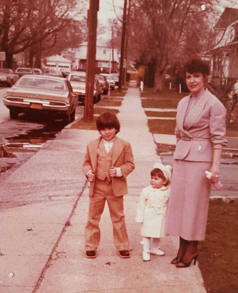 mom stands with two childreb 900x1110 1